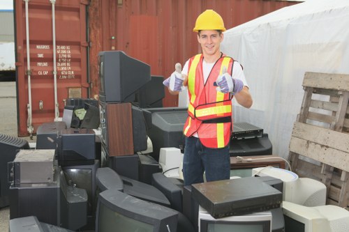 Workers loading segregated recyclables at a transfer station serving urban businesses